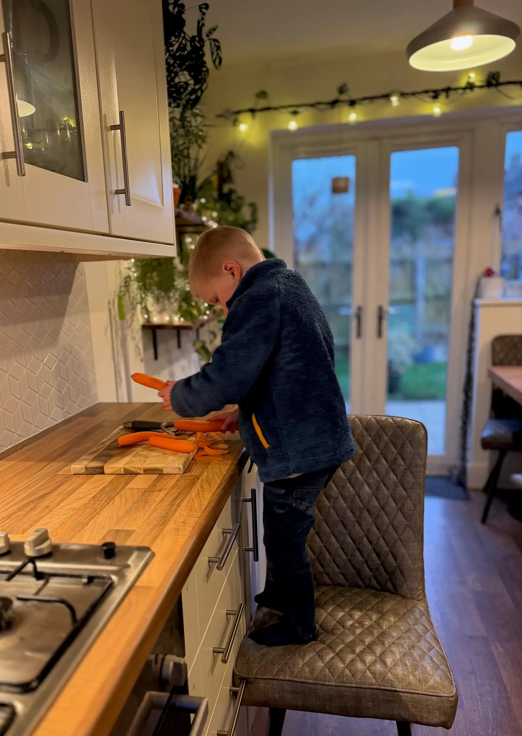 dads son peeling carrots