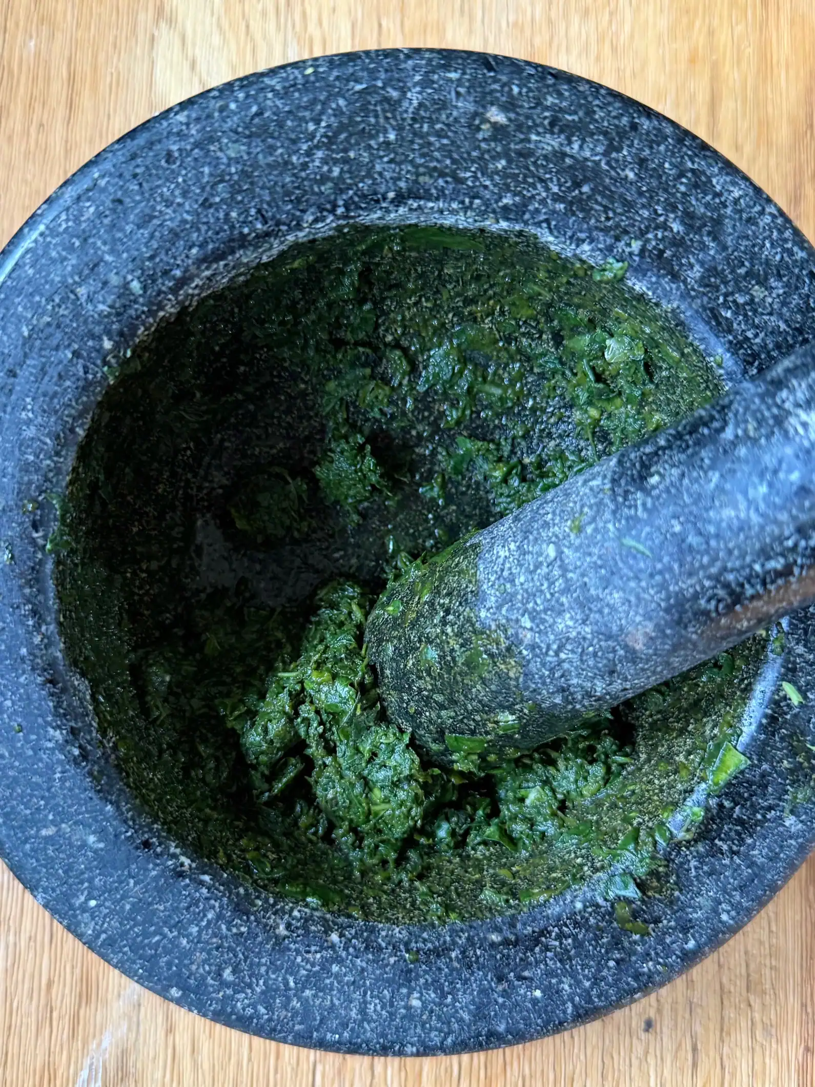 crushed basil in pestle and mortar