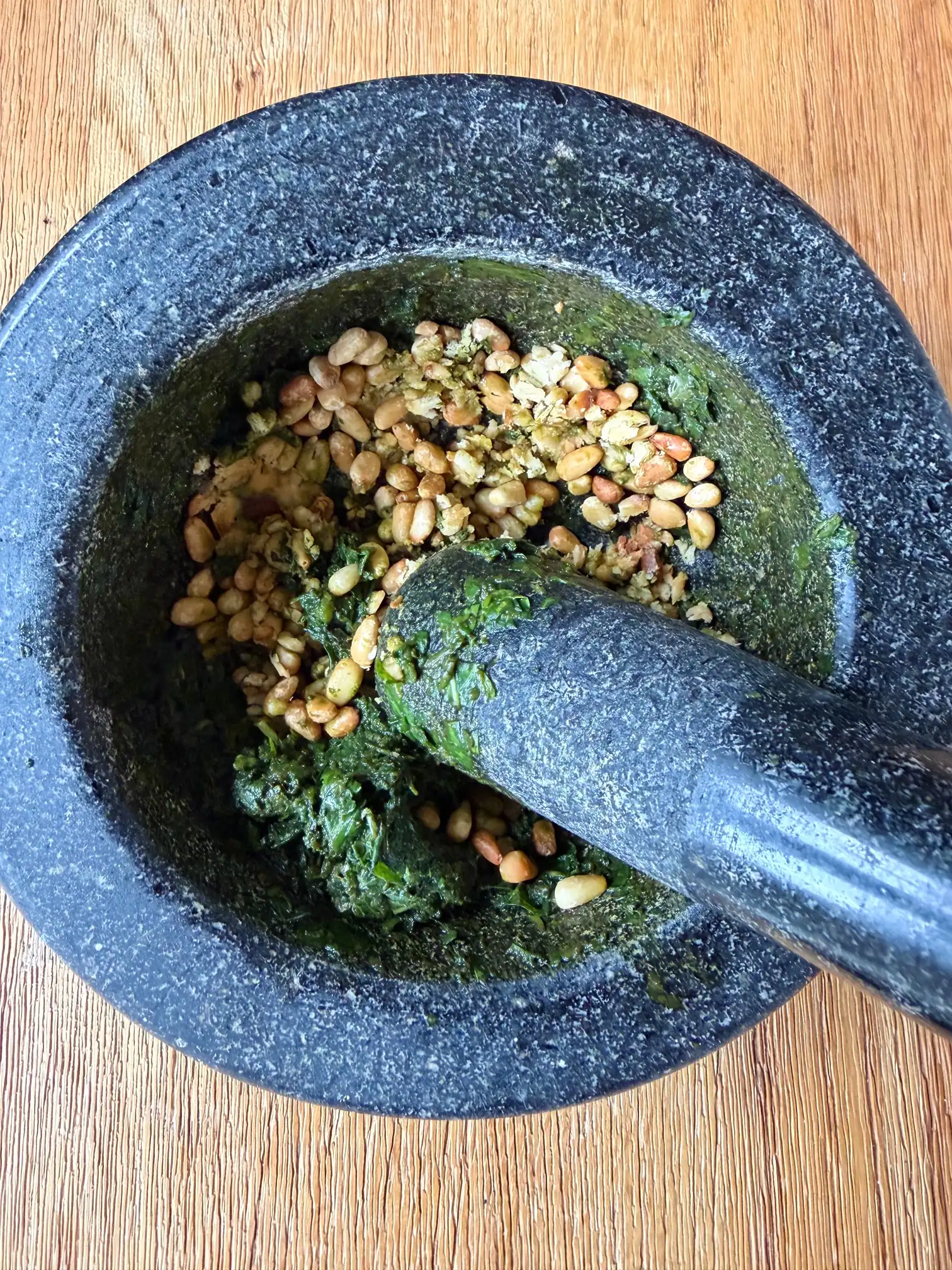 pine nuts crushed in pestle and mortar
