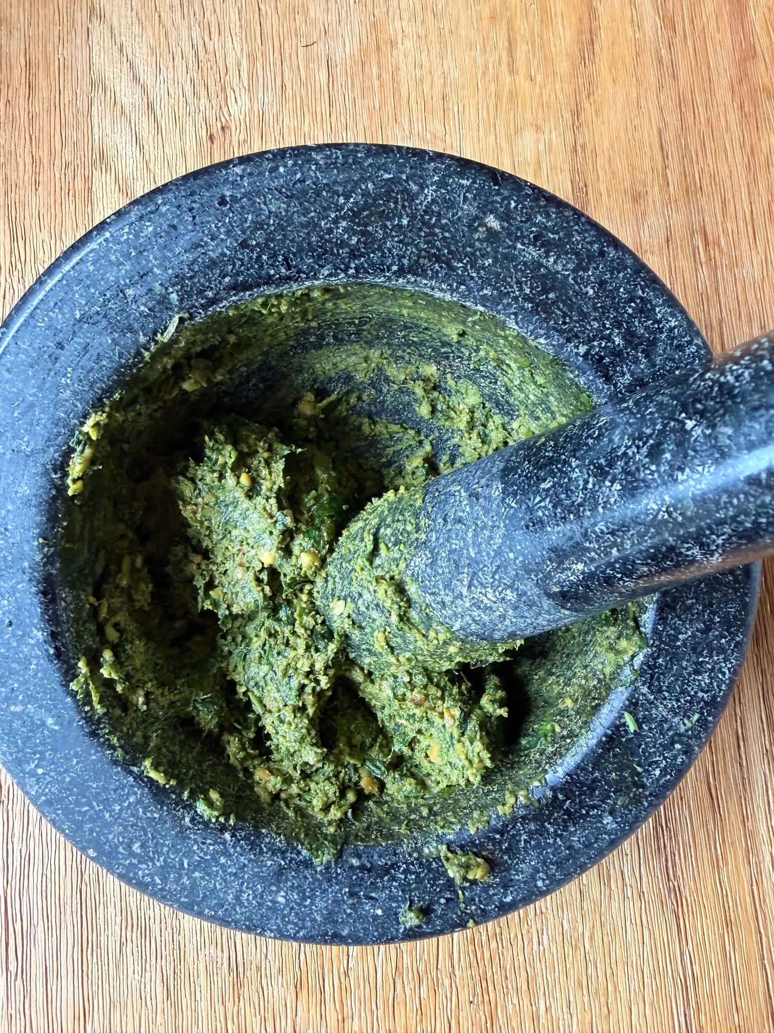 pine nuts in pestle in mortar