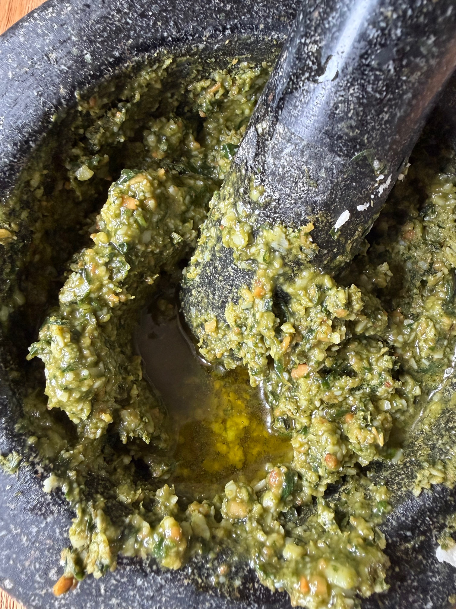adding oil to pesto