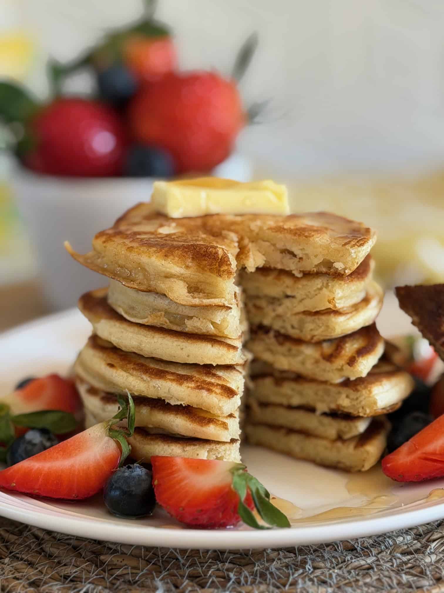 stack of cottage cheese pancakes with fresh red berries