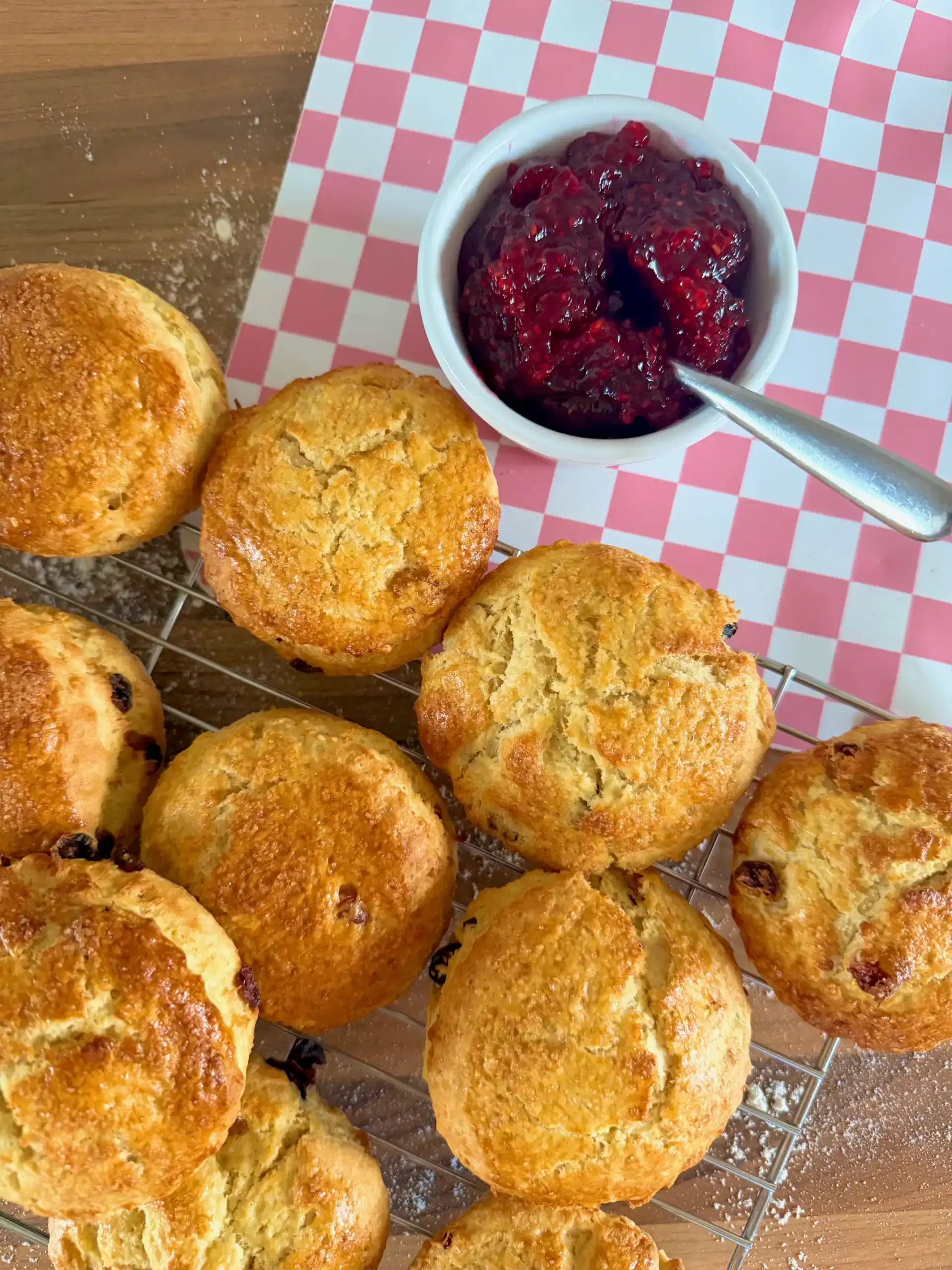Scones cooling on a rack with jam