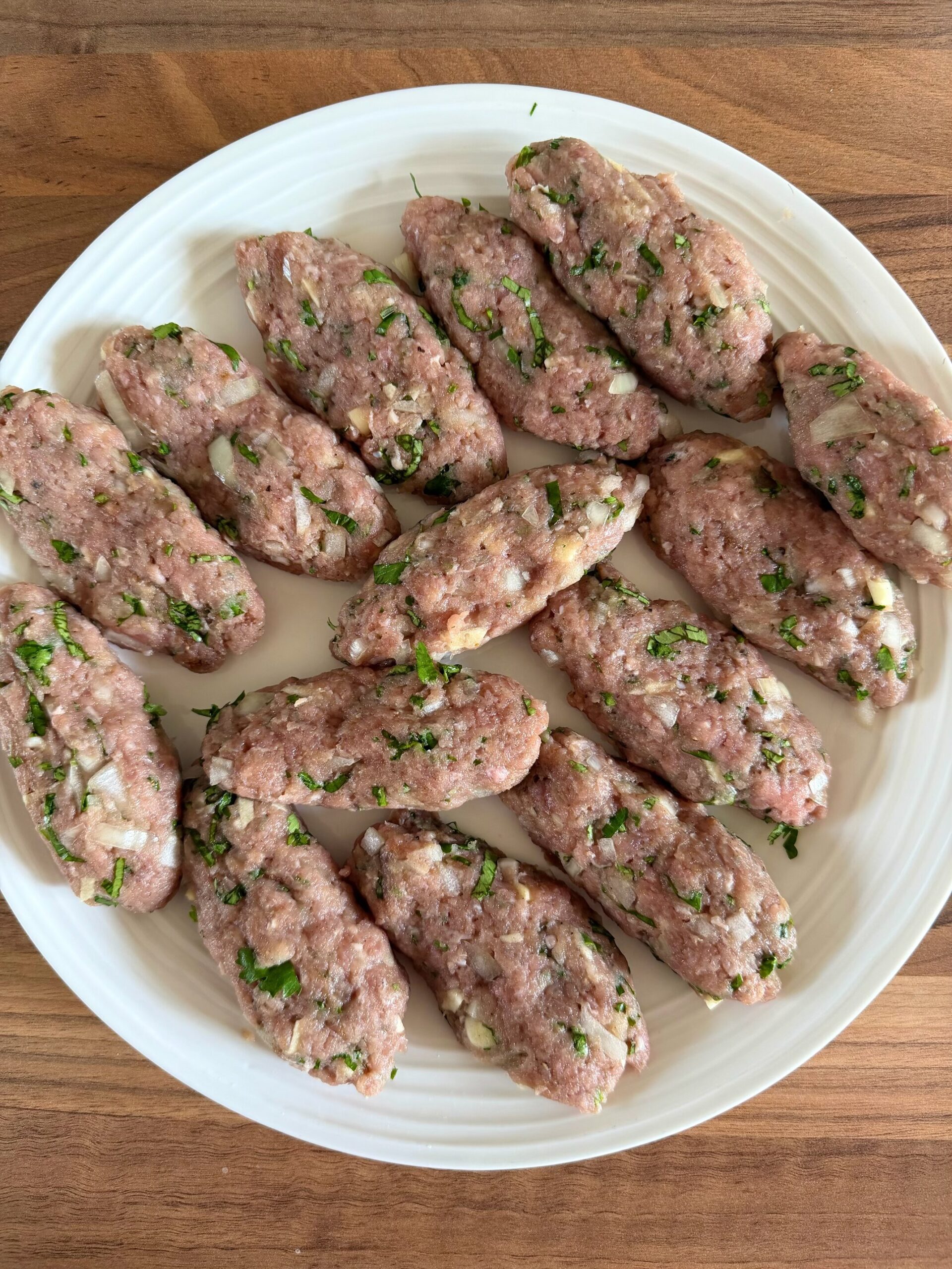 raw turkey koftas on a  plate