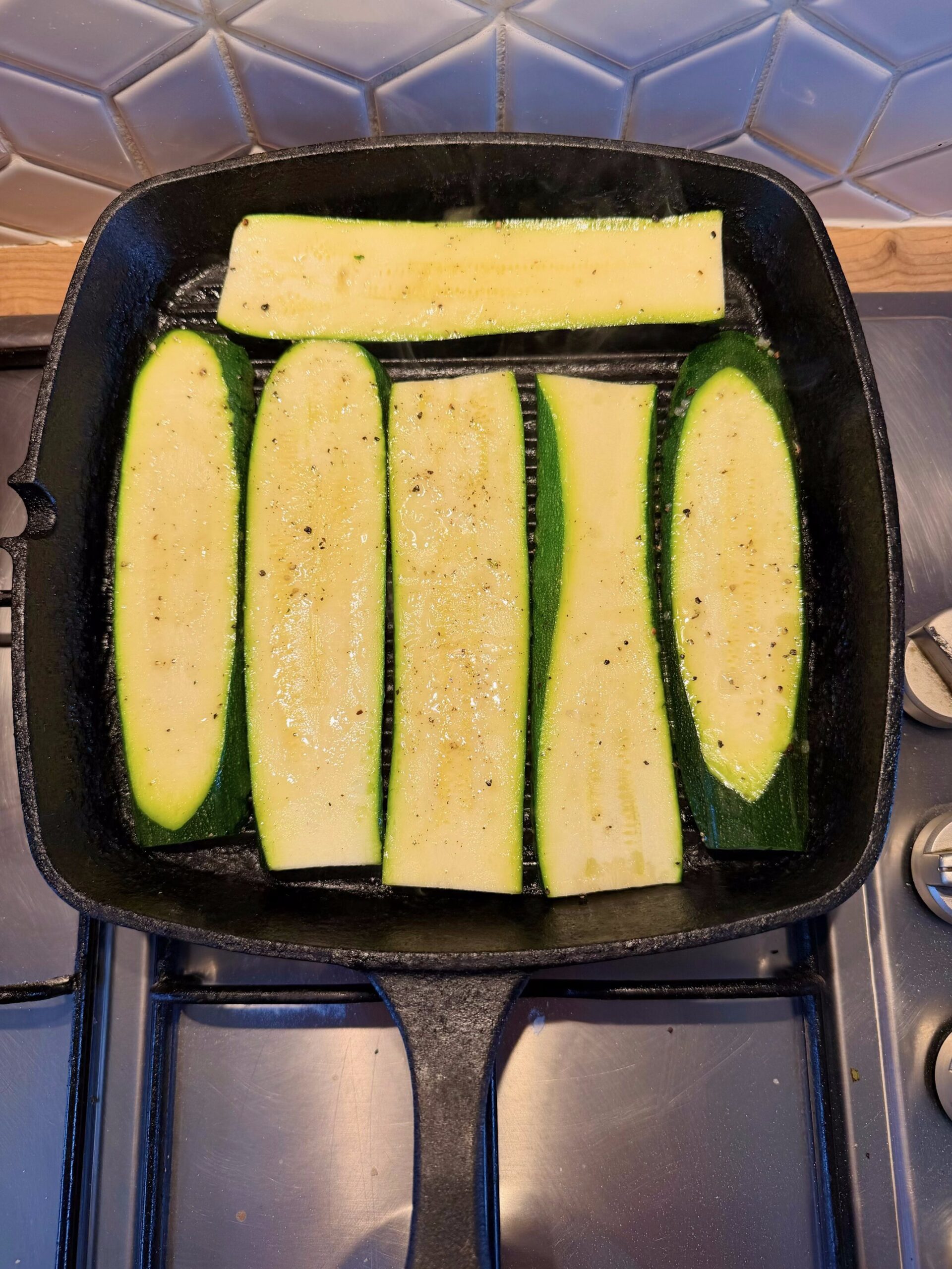 cooking courgette slices on a griddle pan