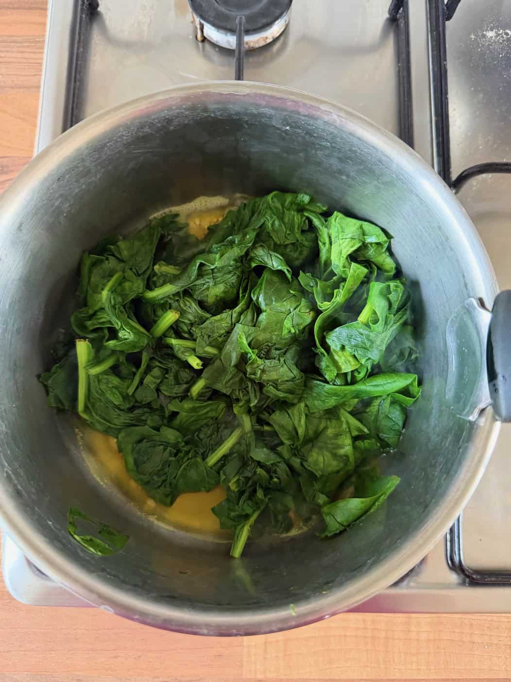 cooking spinach in pan