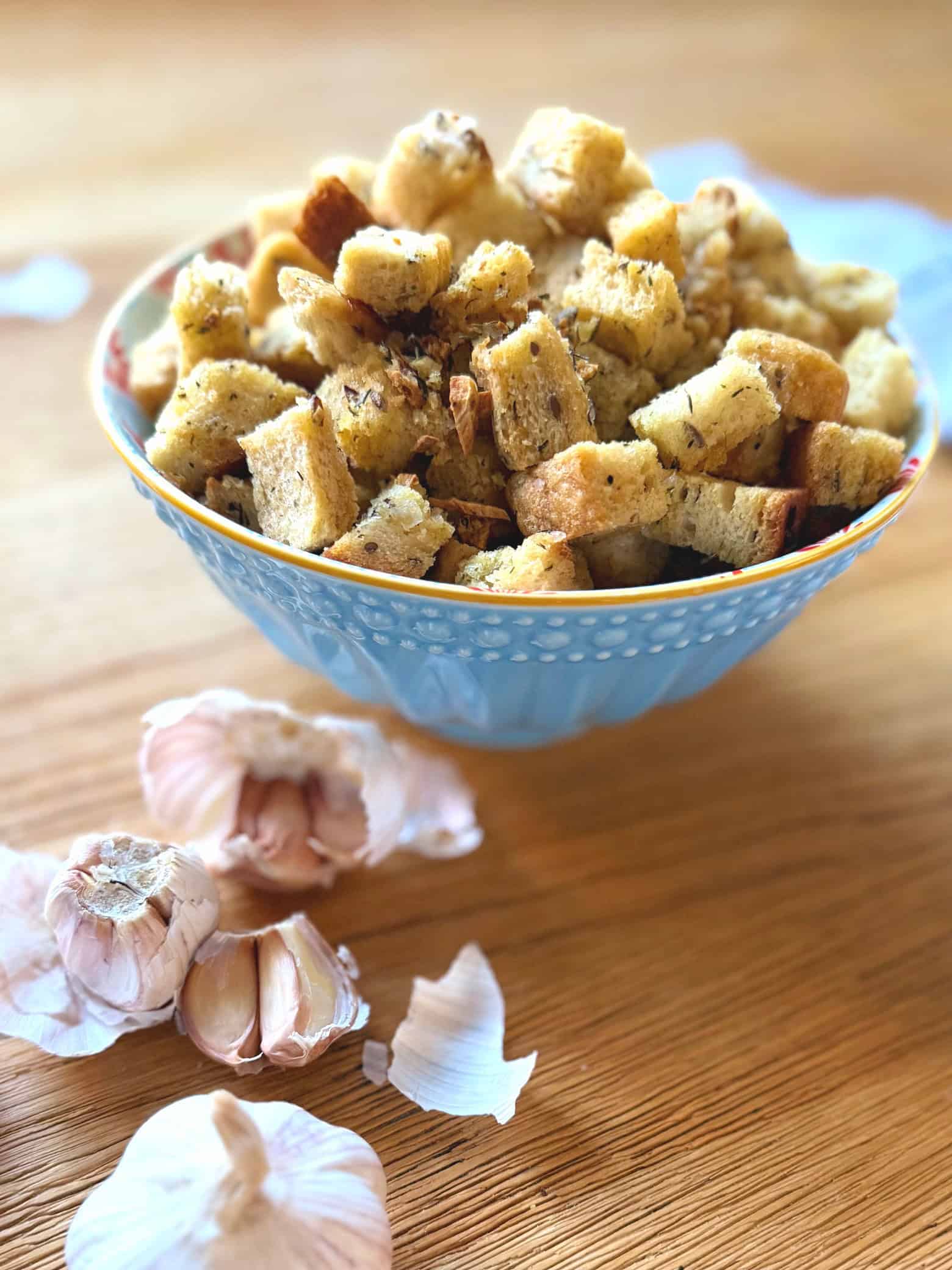 croutons in a bowl with garlic bulb