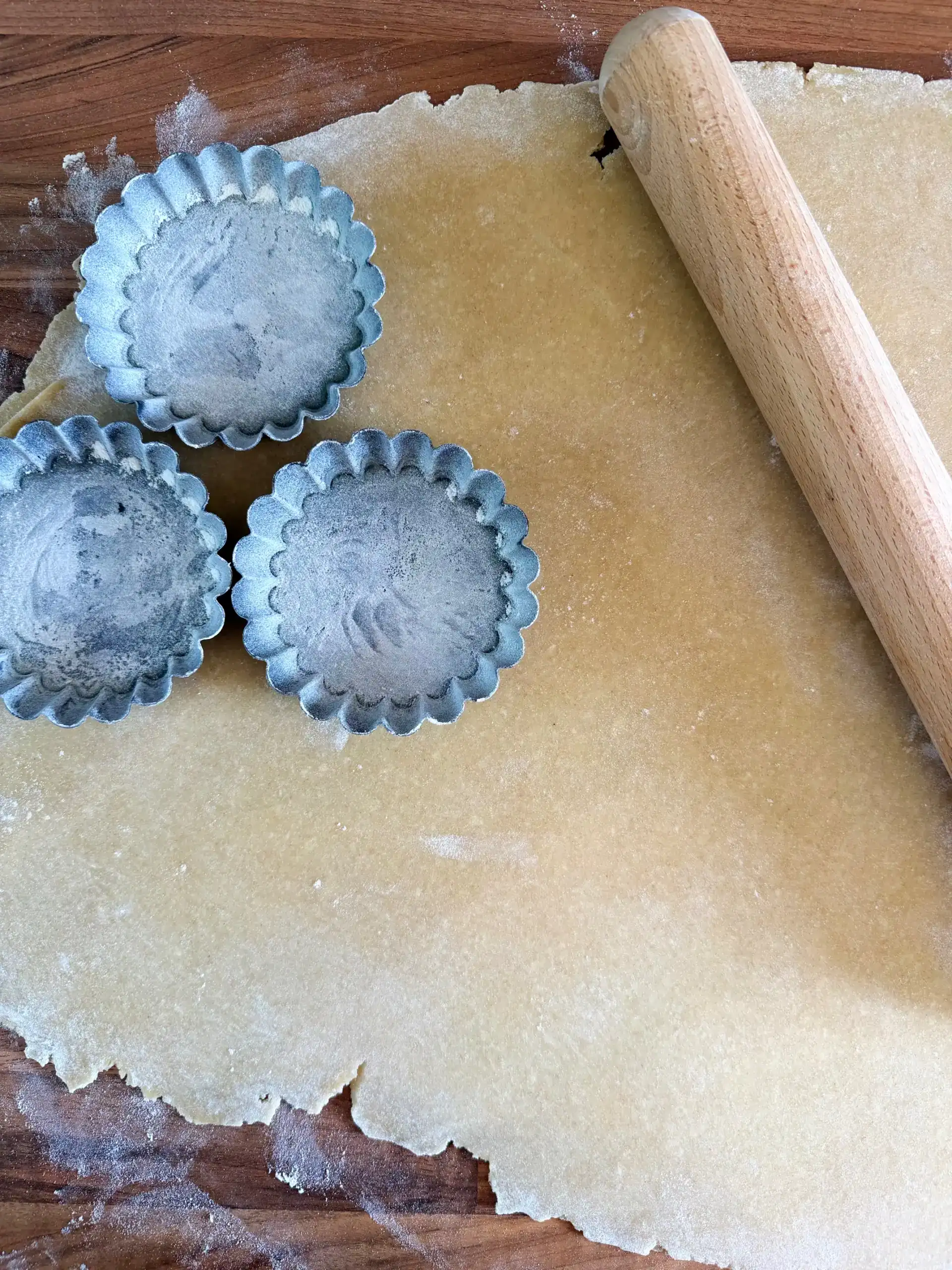 rolling pastry into fluted tart cases