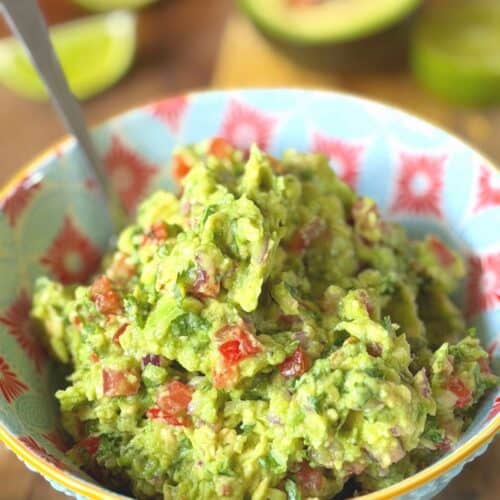 close up of guacamole in a colourful bowl