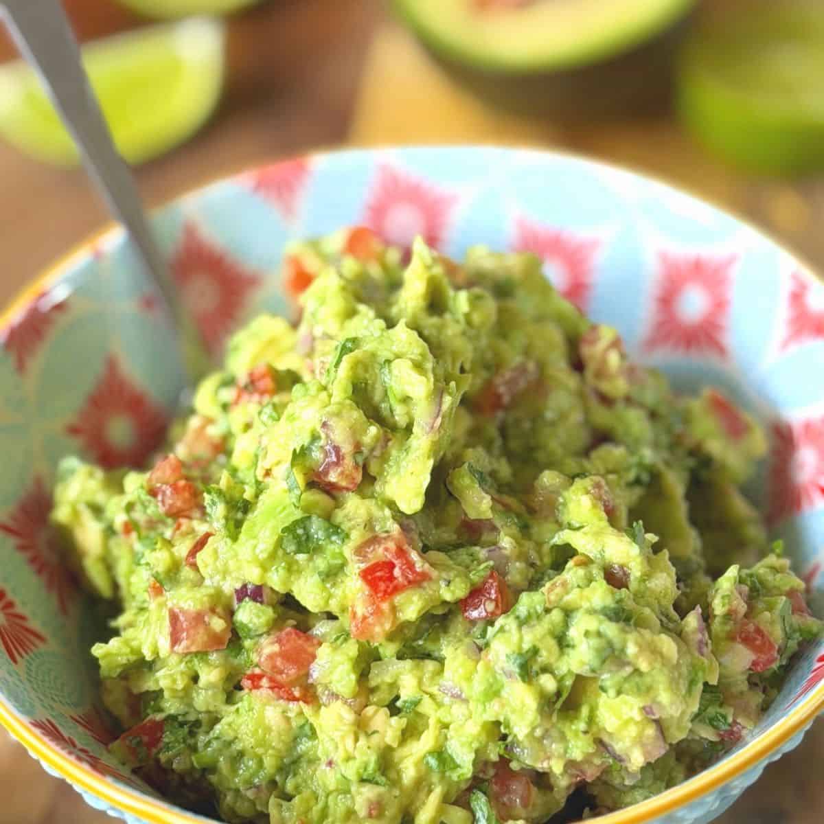 close up of guacamole in a colourful bowl