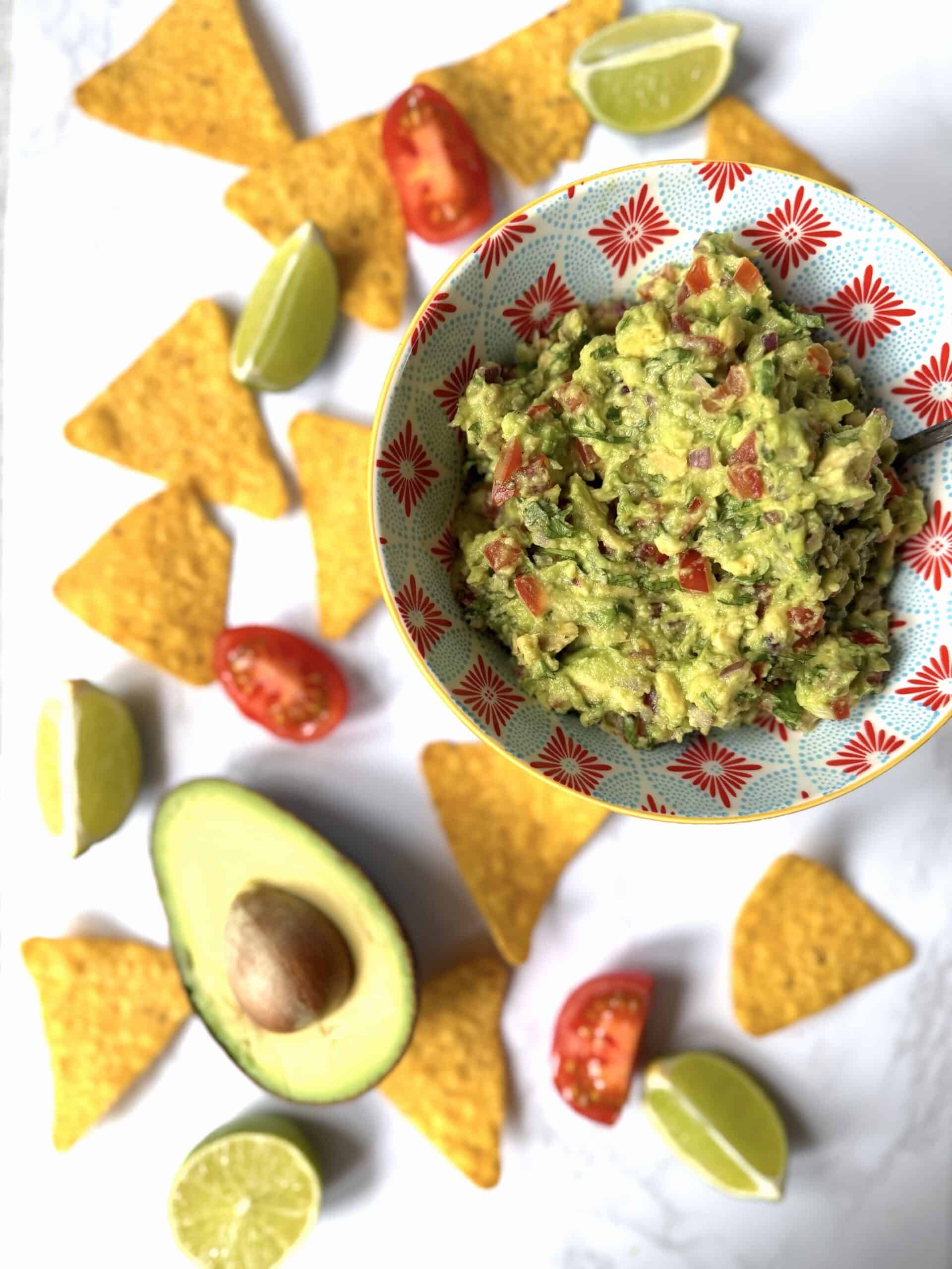 guacamole with tortilla chips, avocado and limes