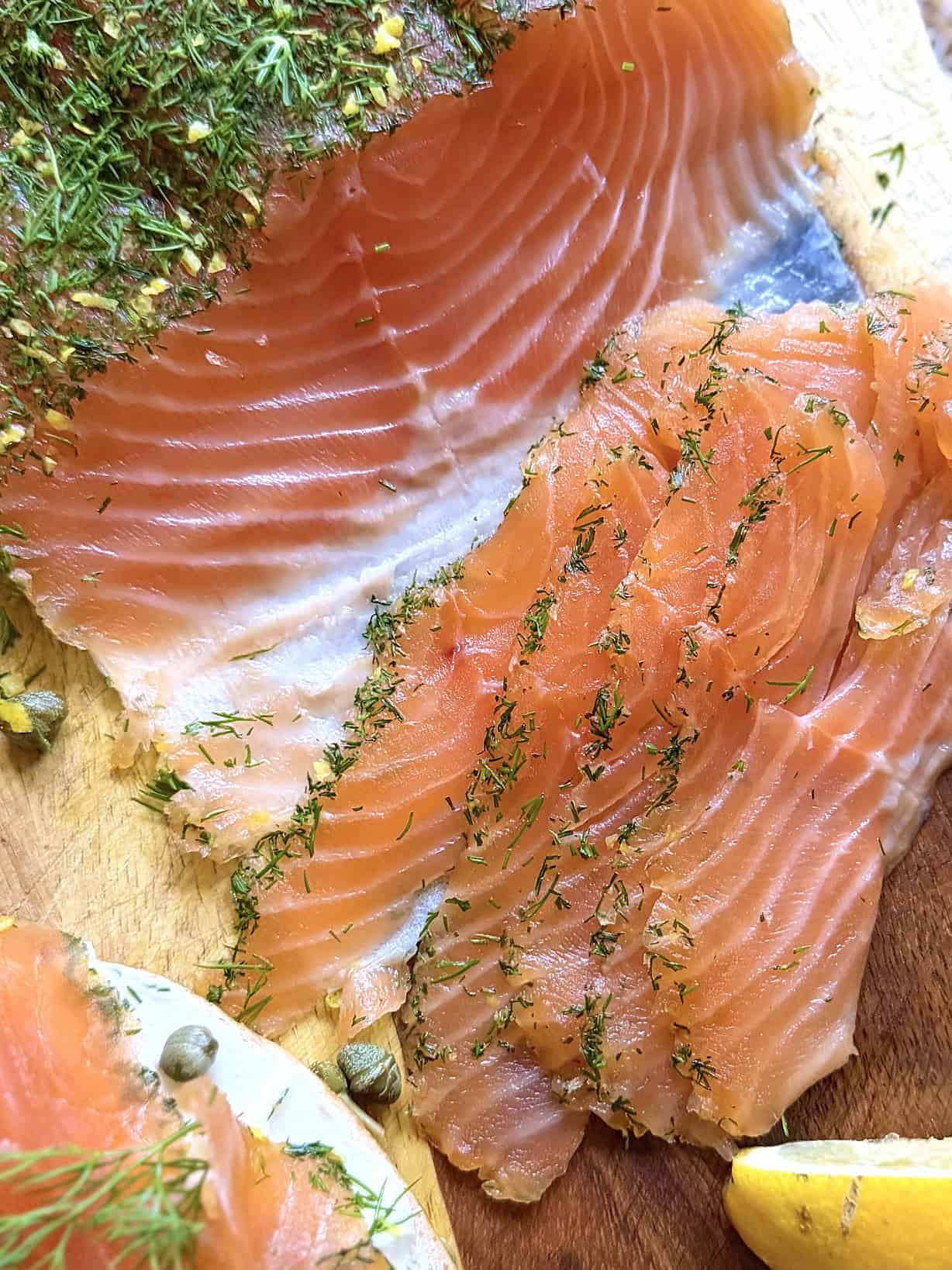 Salmon gravlax sliced with lemon wedge