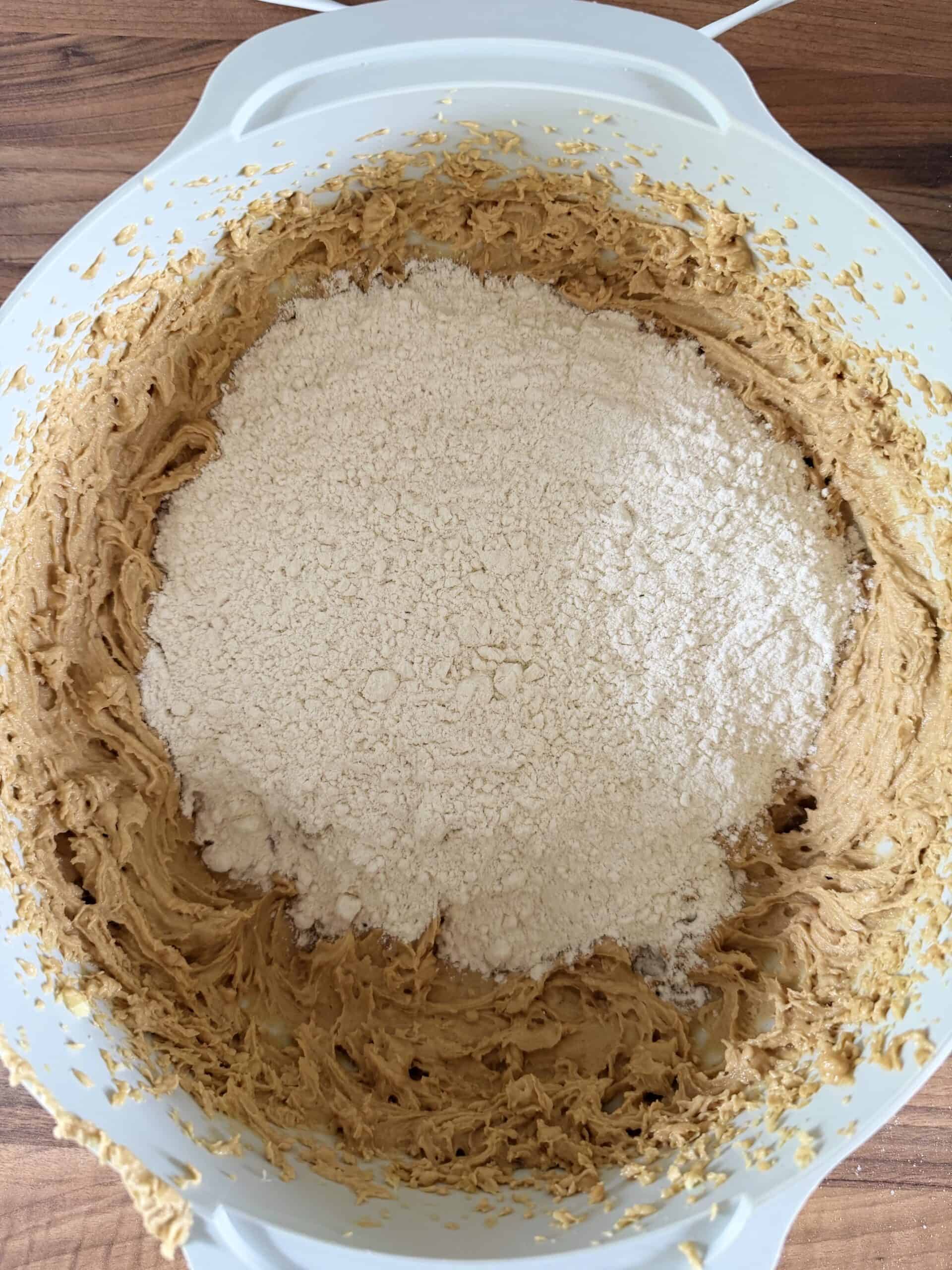 add flour and baking powder to cookie dough in mixing bowl