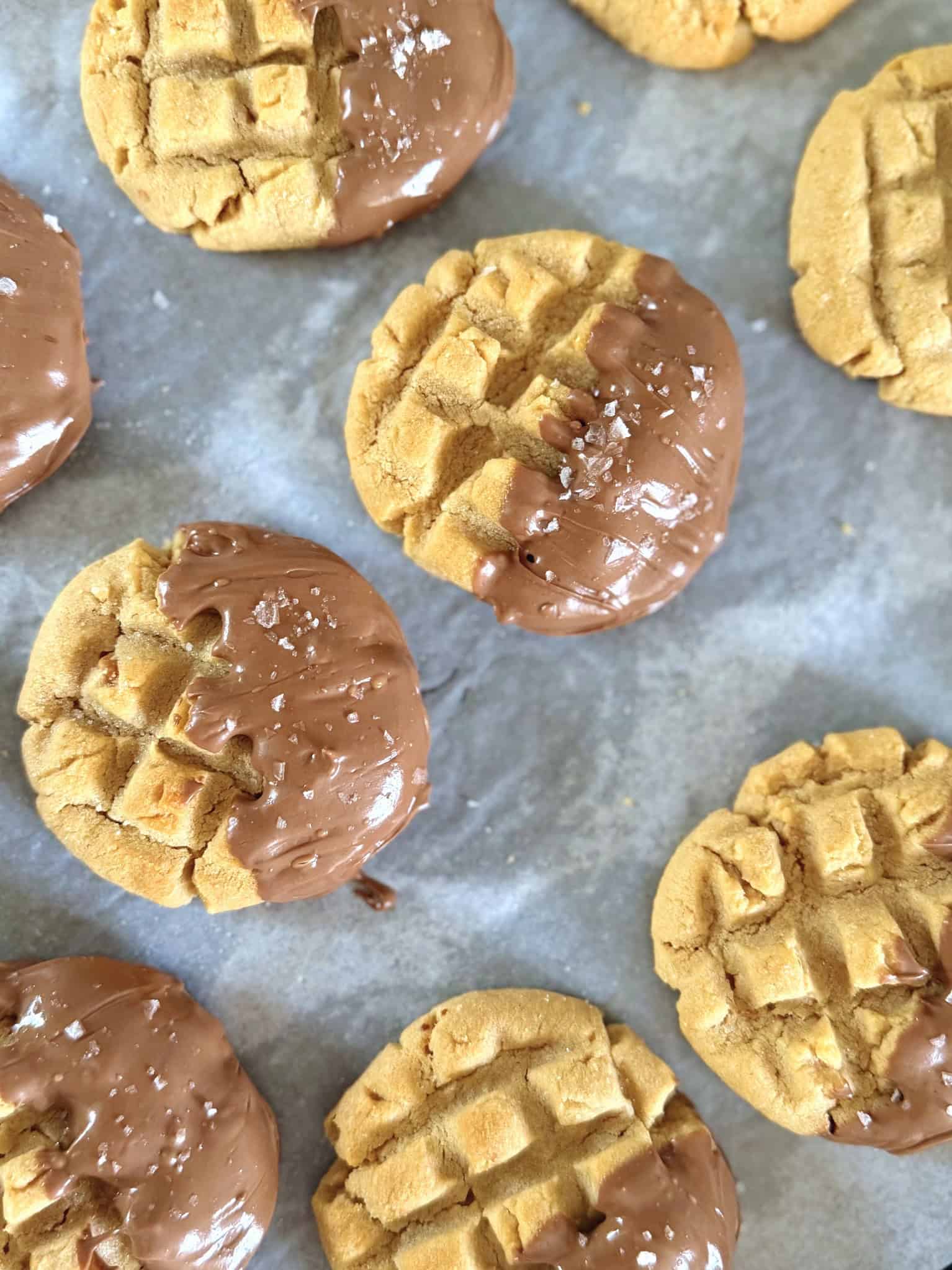 Chocolate dipped peanut butter cookies on cooling rack