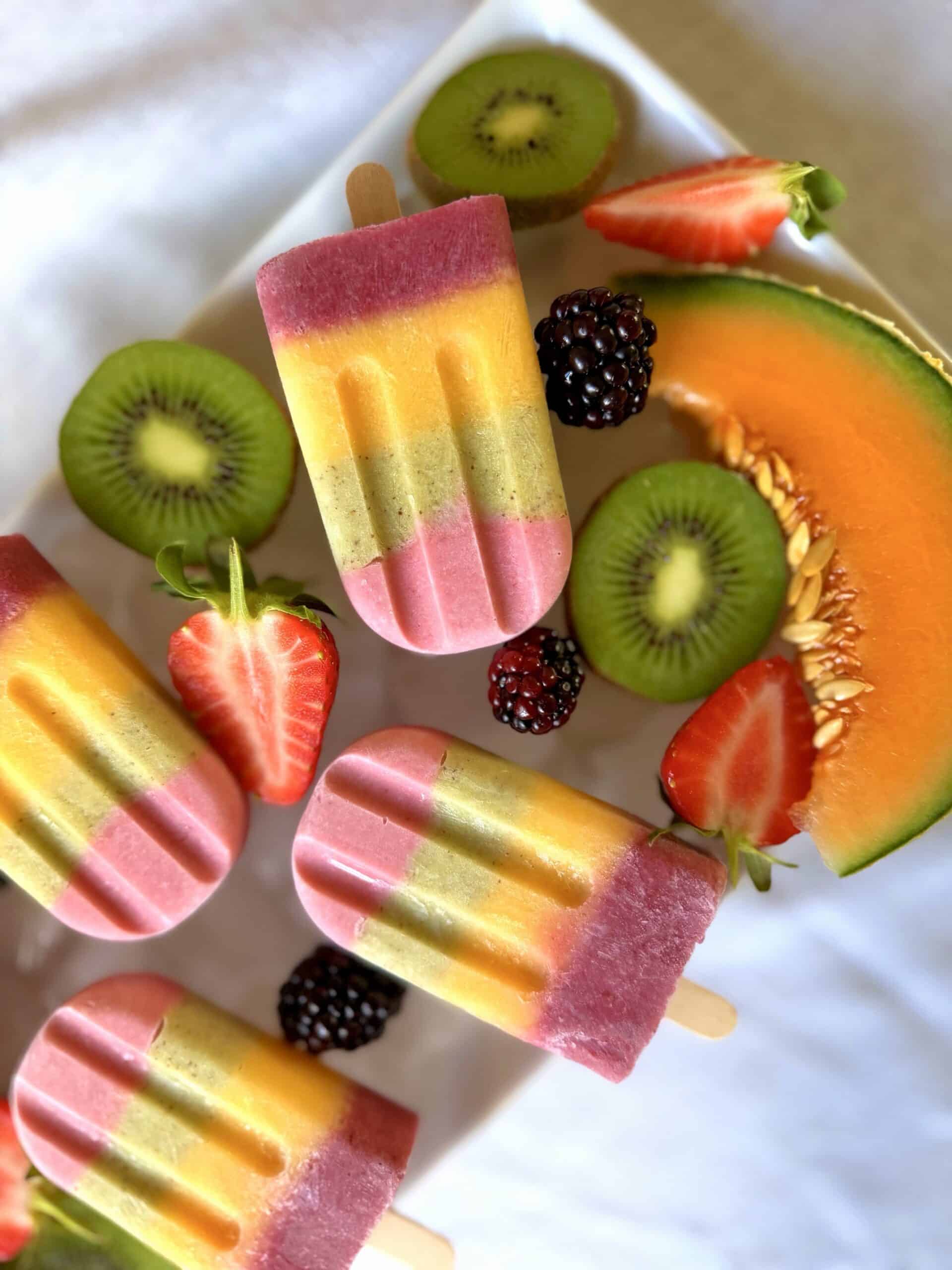 Fruit popsicles on ice with fresh fruit
