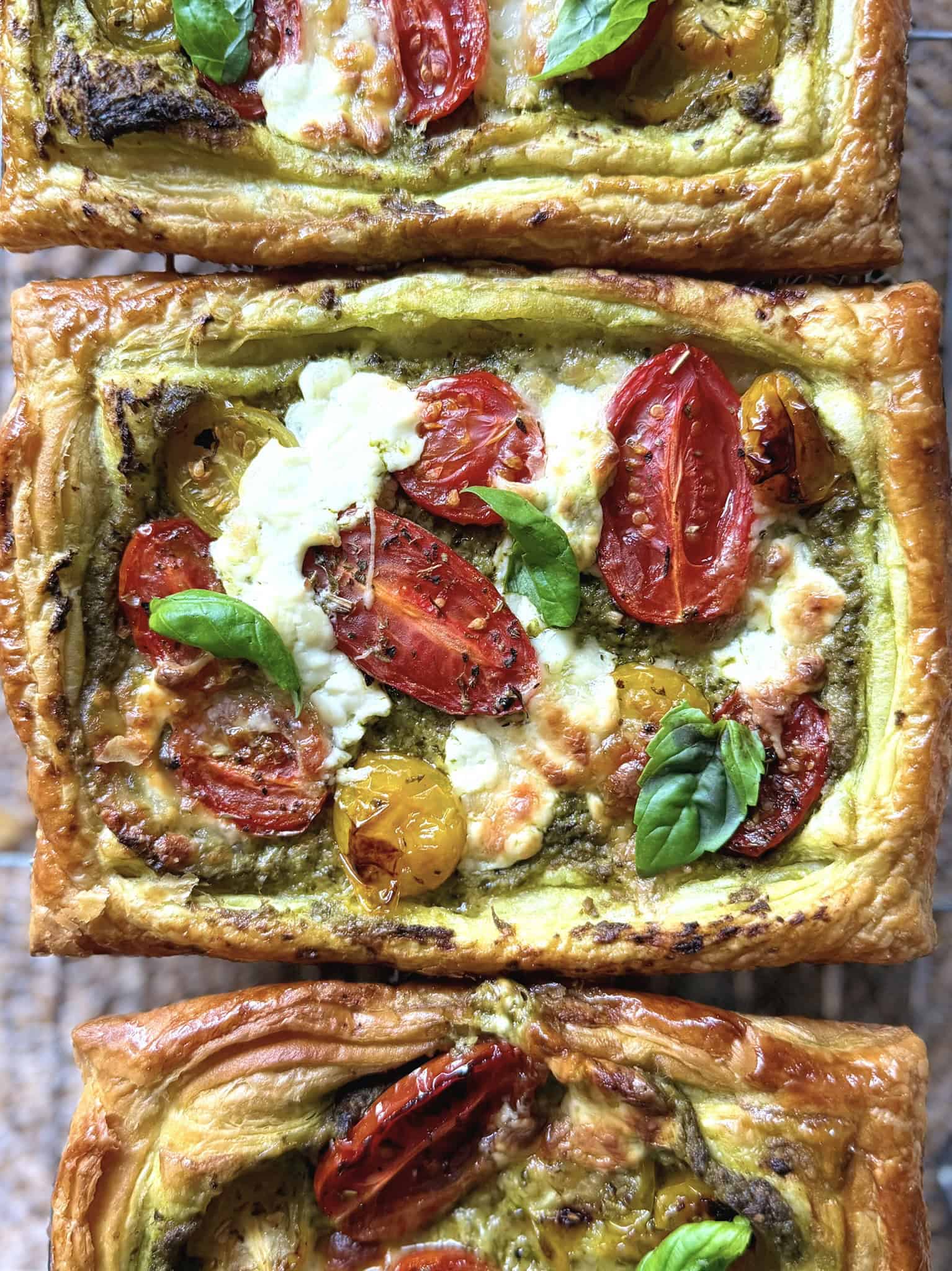close up of tomato, pesto and burrata tart