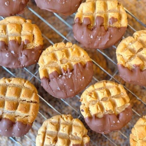 Chocolate dipped peanut butter cookies on a cooling rack