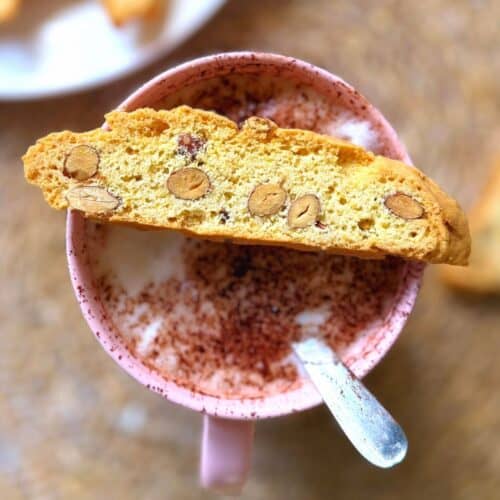Biscotti biscuit balanced over a cup of coffee
