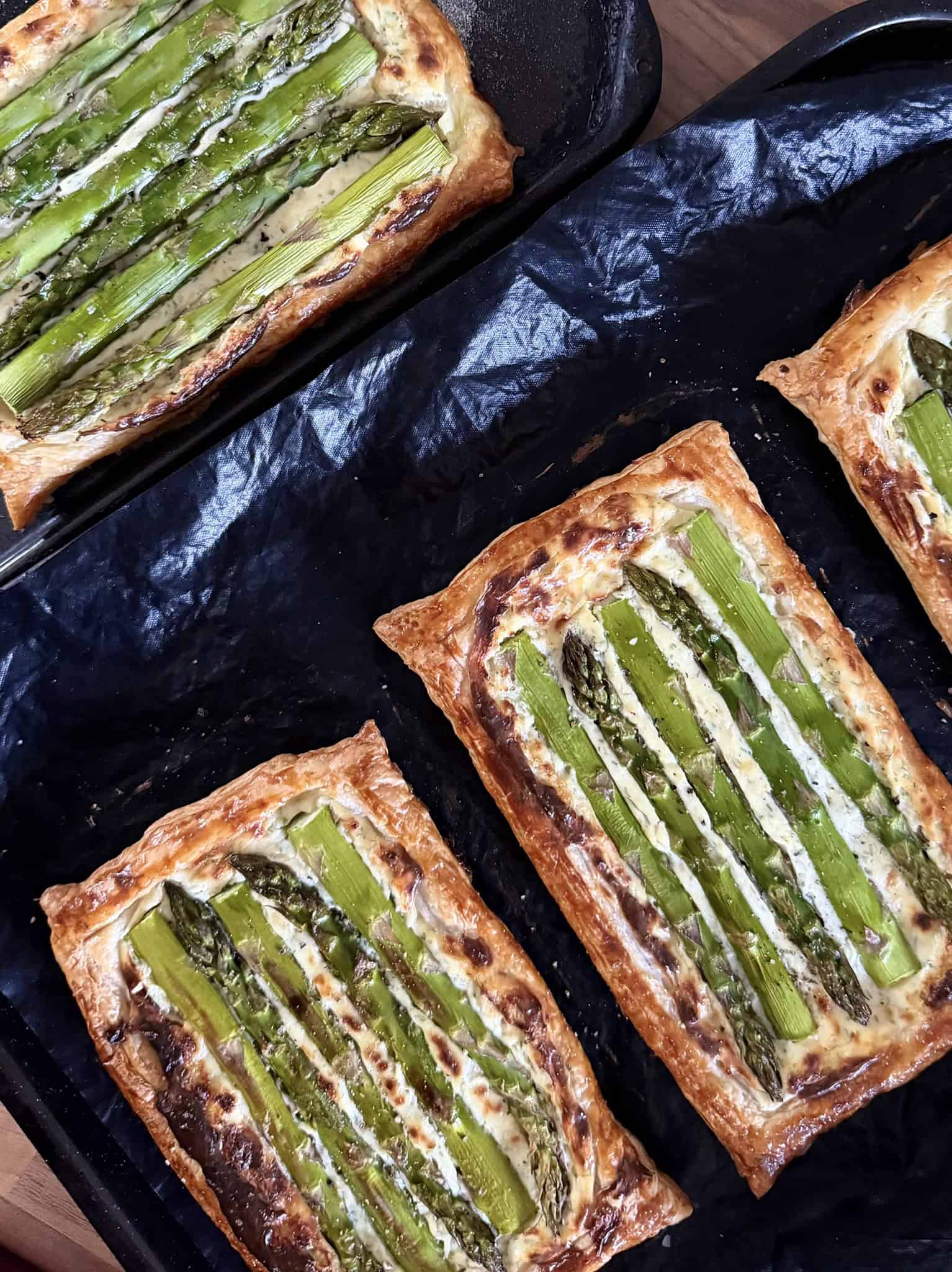 cooked asparagus tarts on baking tray