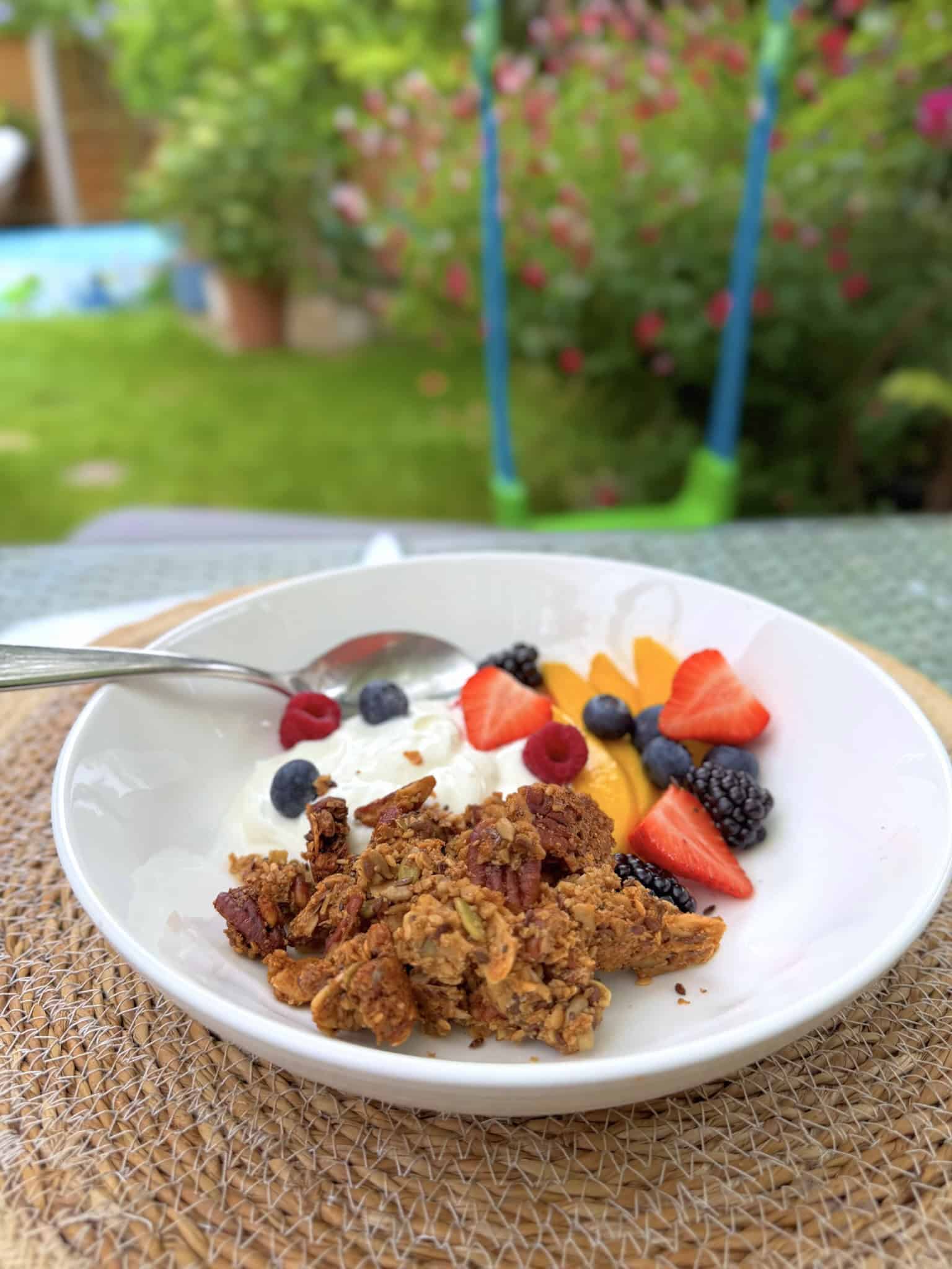 granola, yogurt and fruit in a  bowl outside