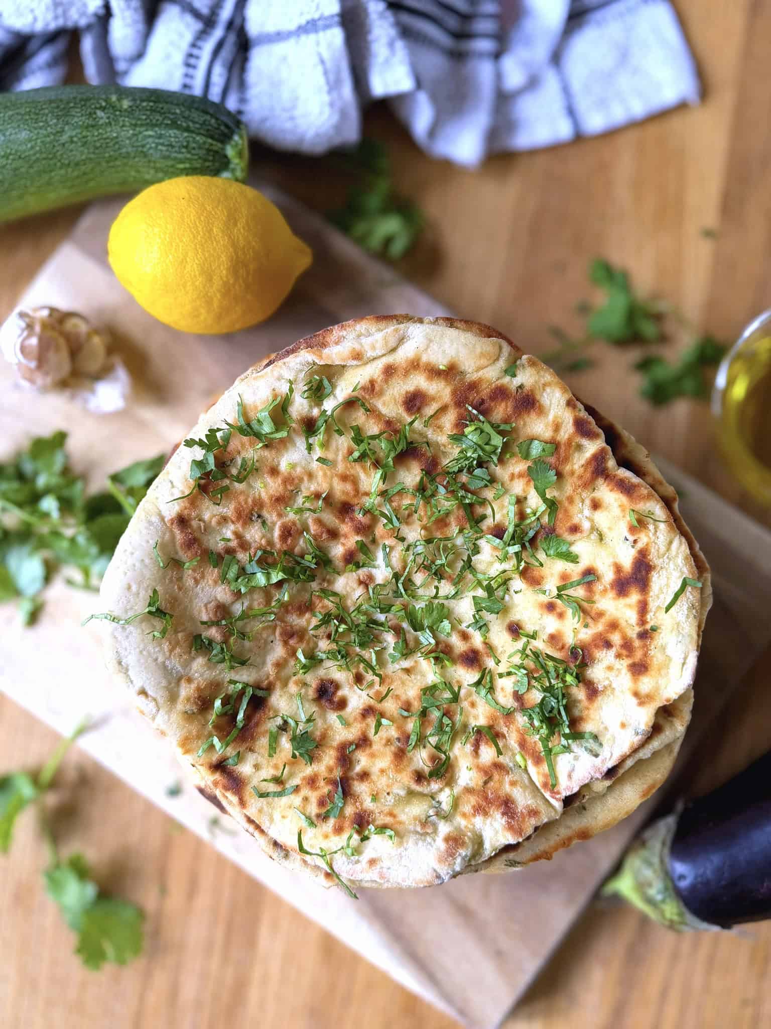 flatbreads with lemon, parsley and garlic on a chopping board