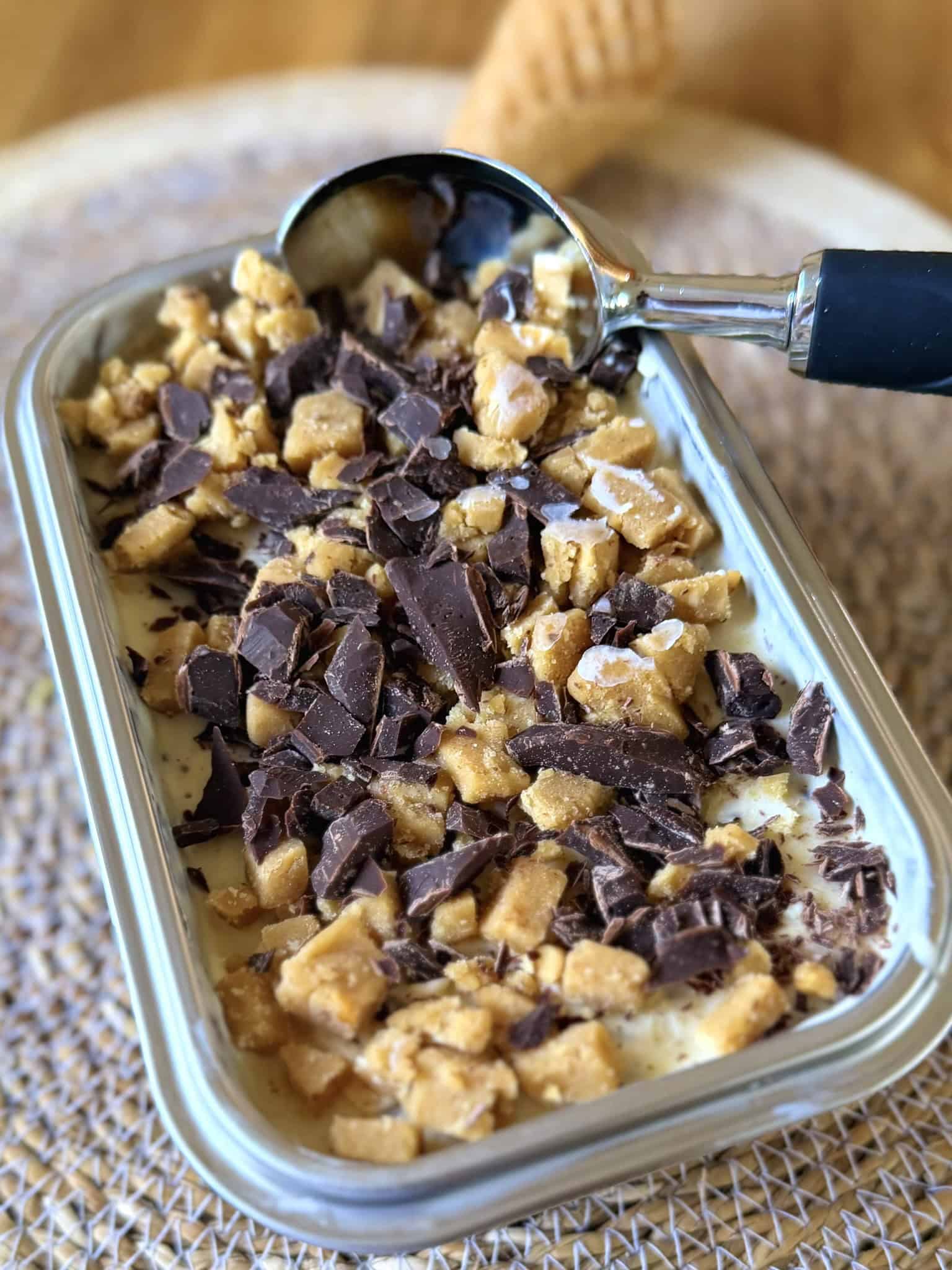 Peanut butter cookie dough and chocolate chip ice cream in a metal container