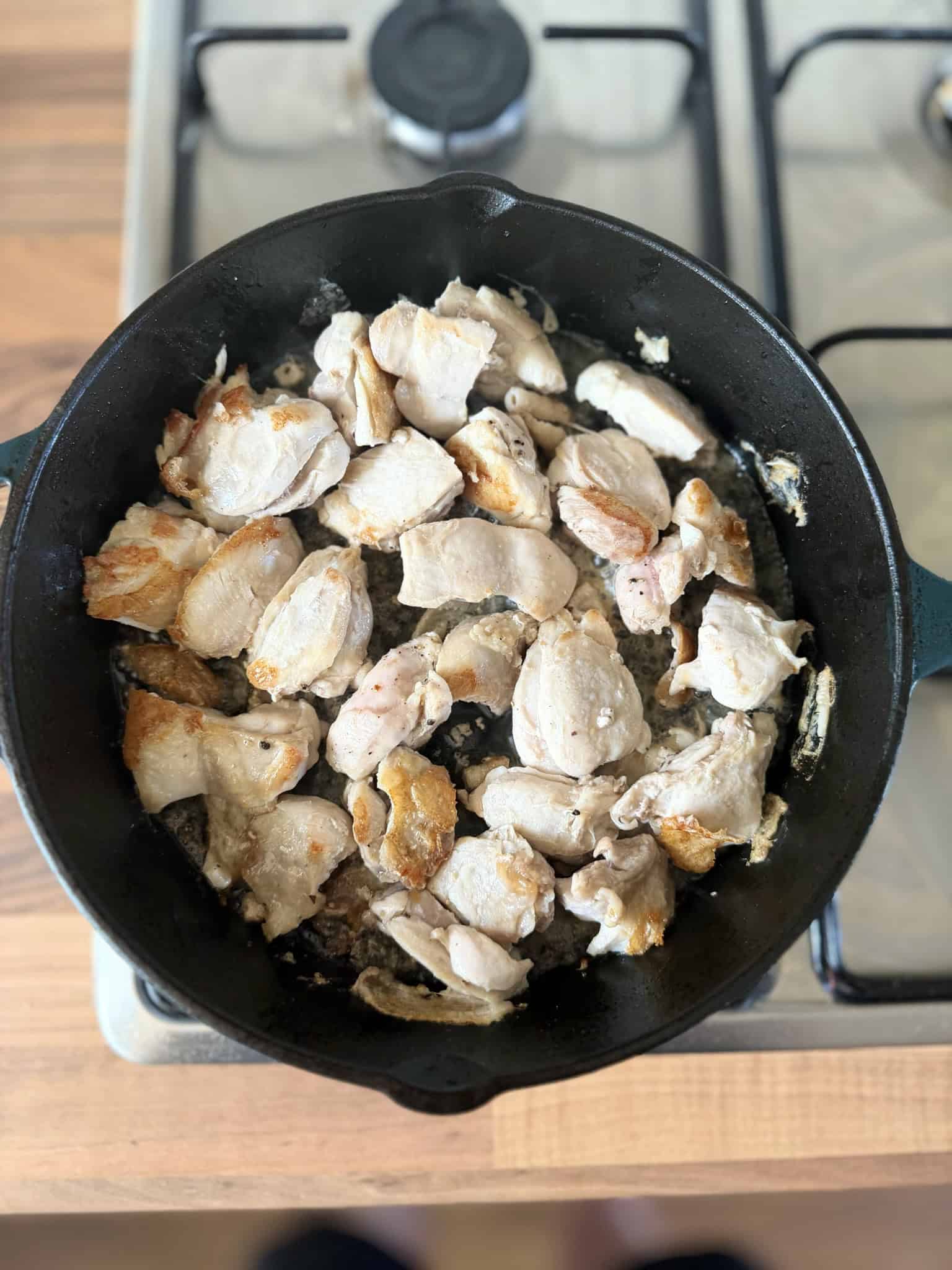 Chicken cooking in a iron skillet