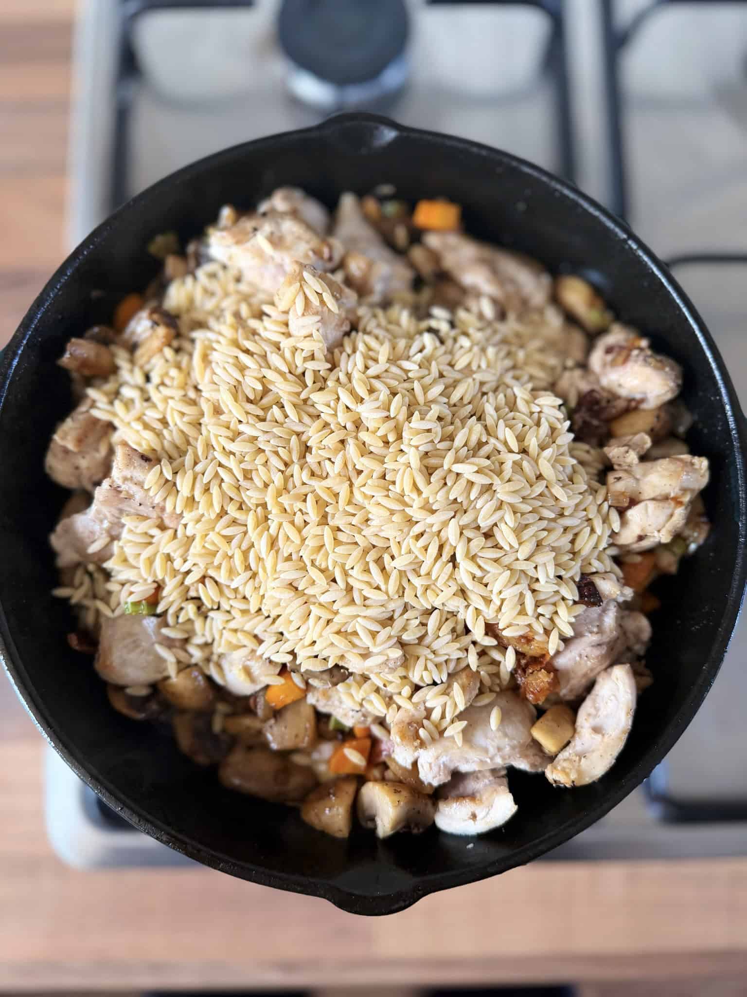 Adding orzo to the skillet