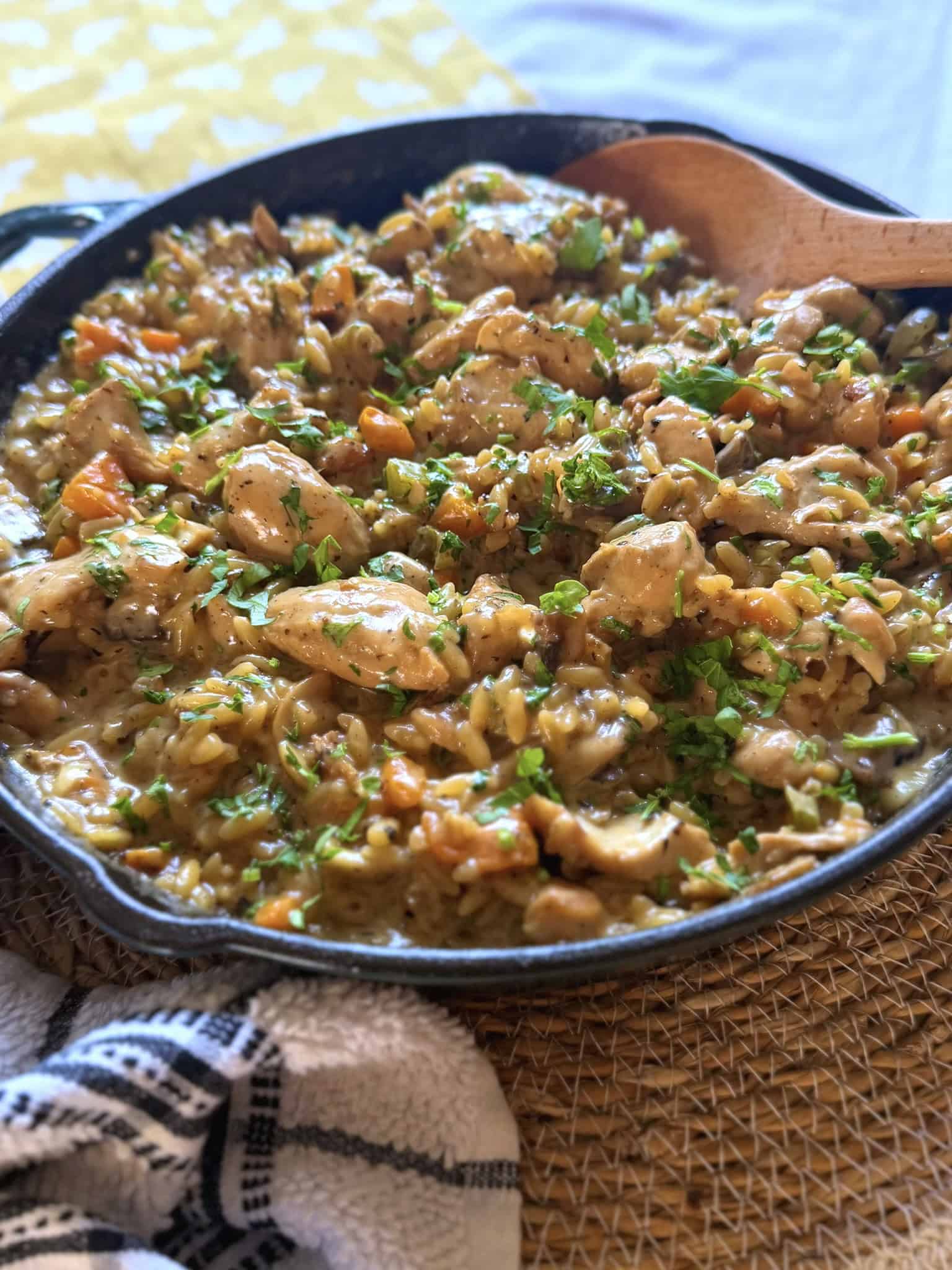chicken and mushroom pasta in an iron skillet at an angle