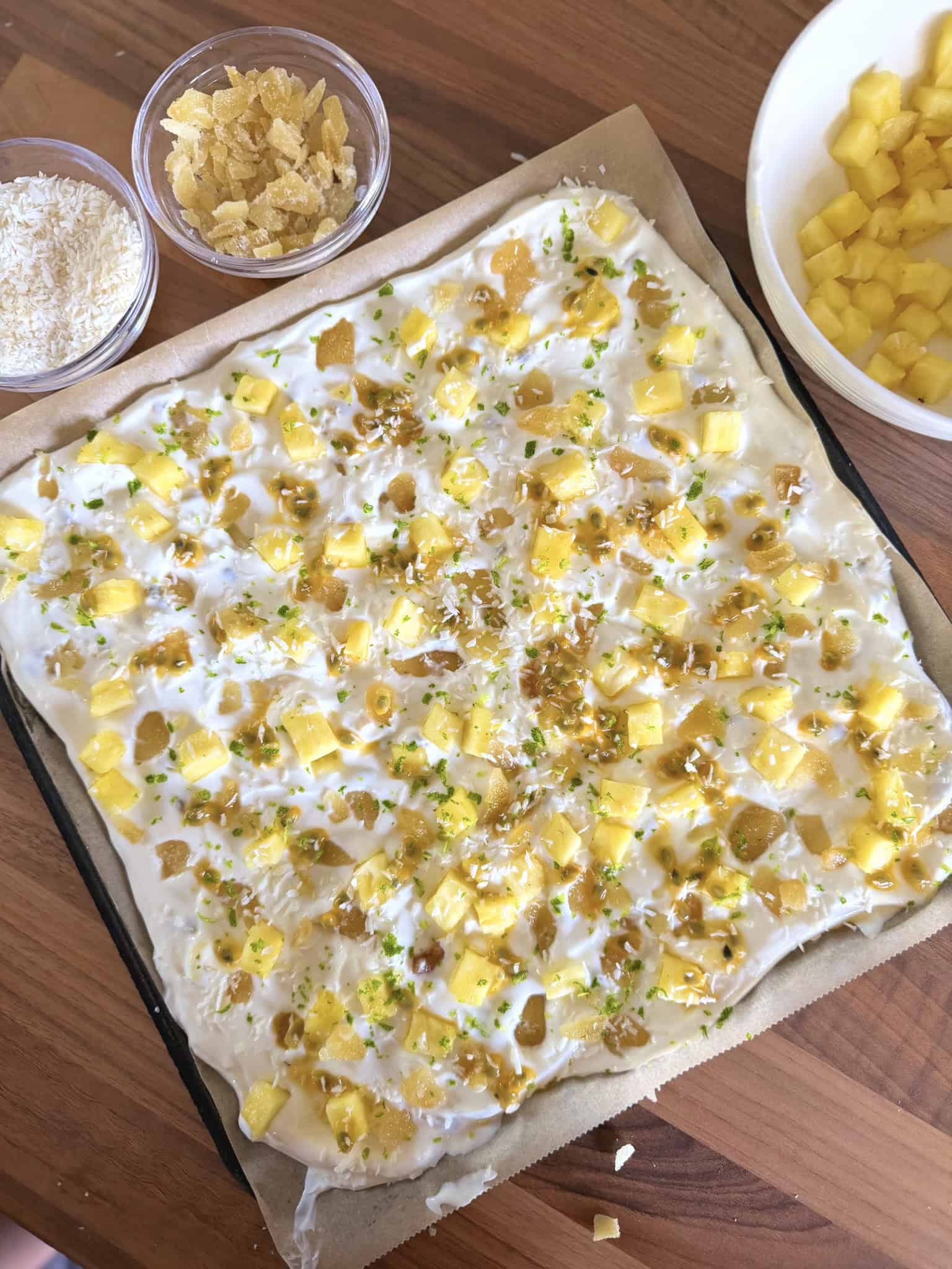 greek yogurt bark on a tray with a small bowl of ginger