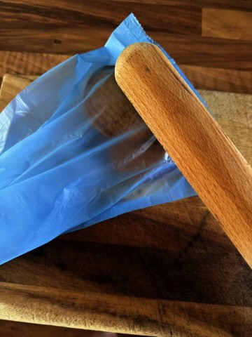 crushing biscuits with a rolling pin