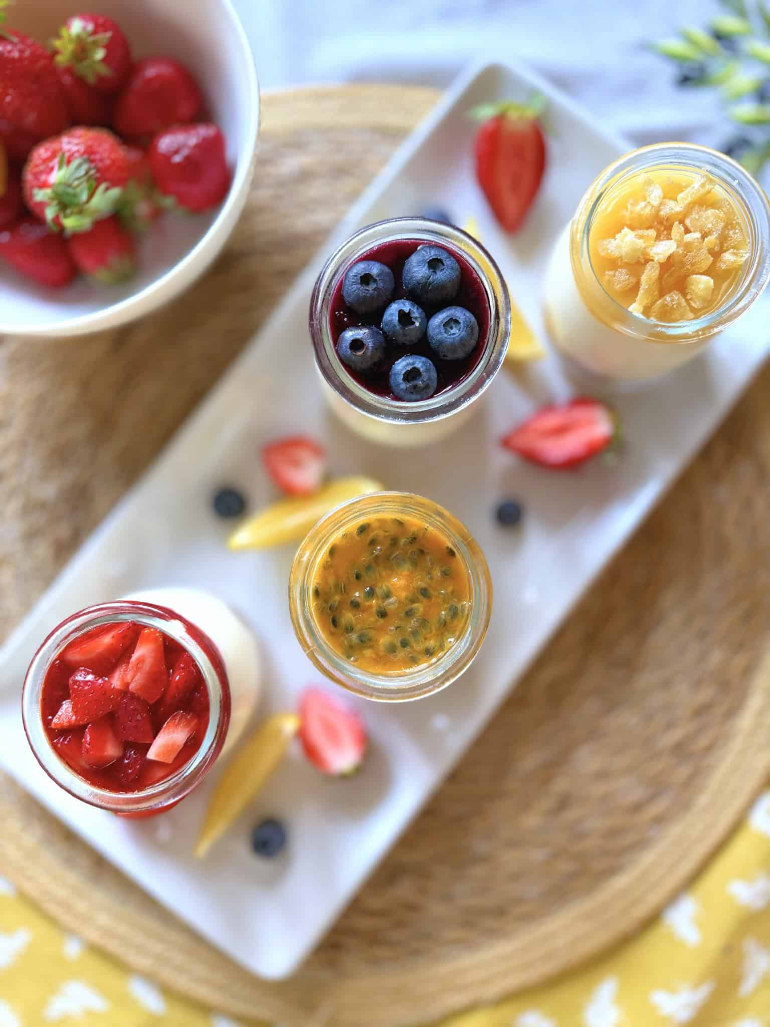 Mini cheesecakes on a plate with fresh fruit